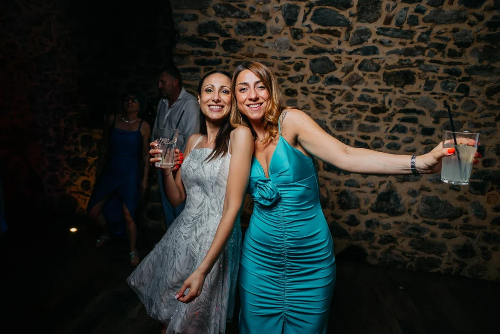 Dream Wedding at Villa Le Due Torrette in Erba: The Elegance of a Lake Como Celebration 92 Group of women dancing and laughing during Lake Como wedding reception