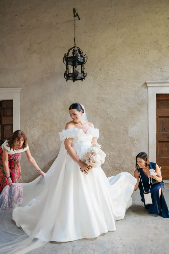 Bride exiting the convent with gown and bouquet, ready for the ceremony