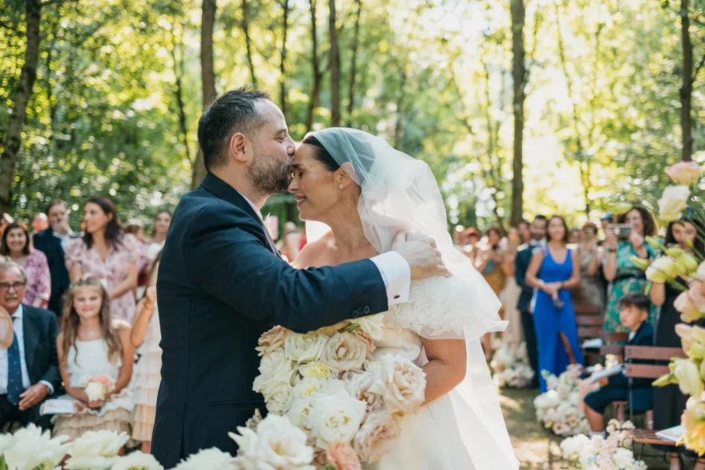 Bride and groom embracing after the ceremony in the forest of Convento dell’Annunciata