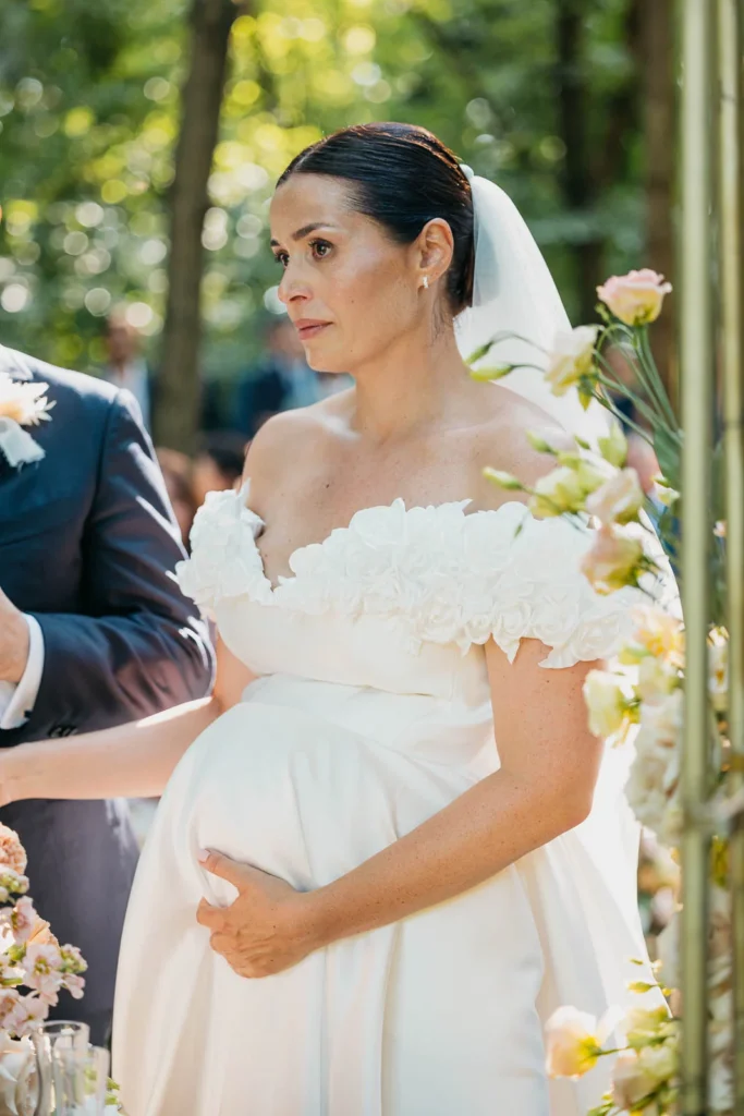 Bride holding her child while waiting to walk down the aisle