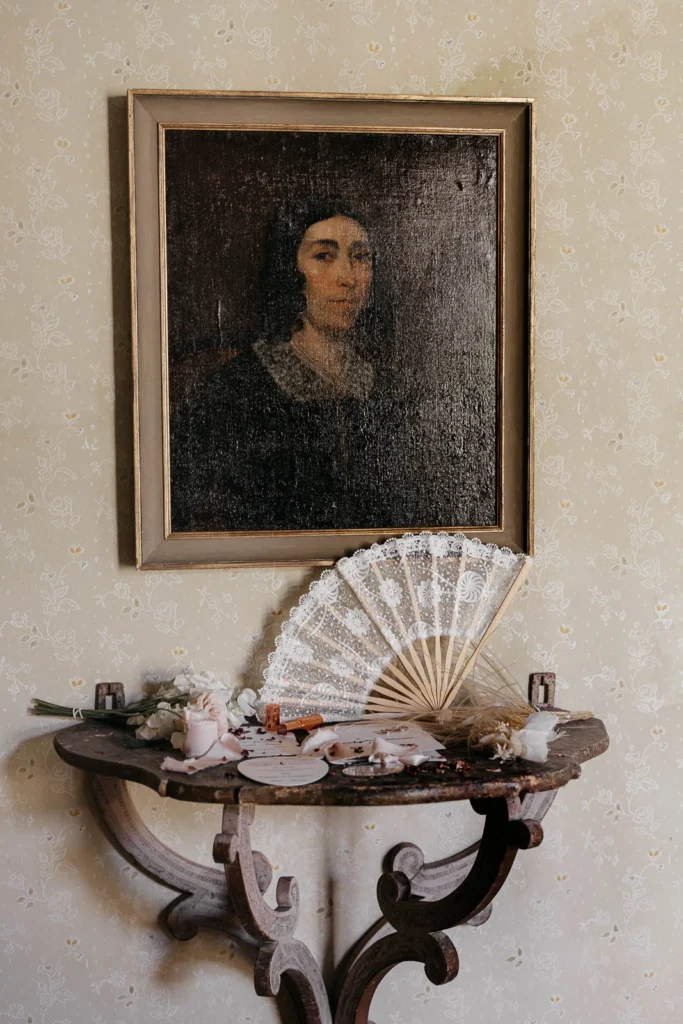 Elegant still life of antique fan and portrait at the wedding venue