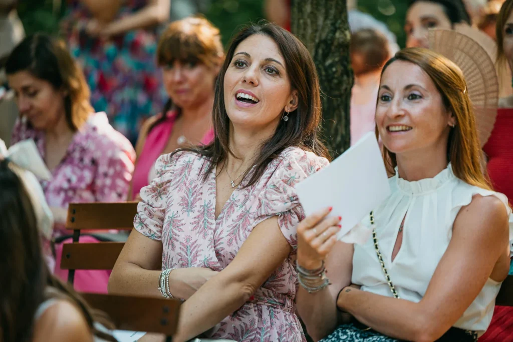 Wedding guests smiling and enjoying the heartfelt atmosphere