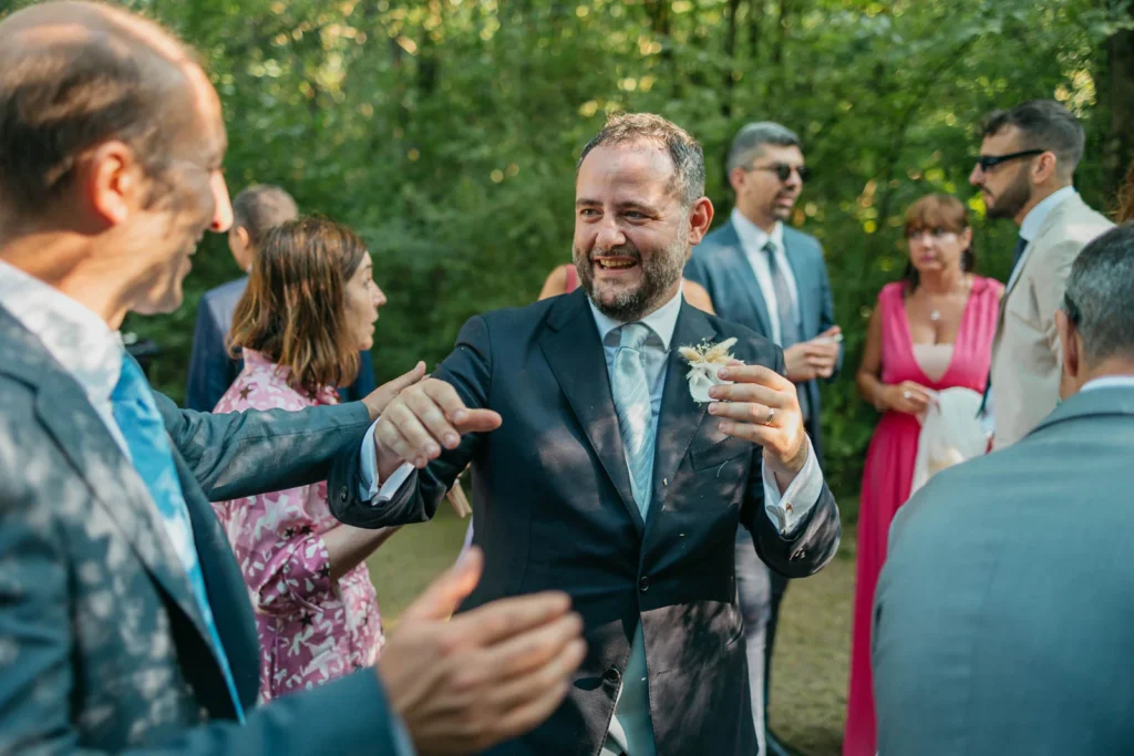 Groom joyfully greeting guests and receiving congratulations