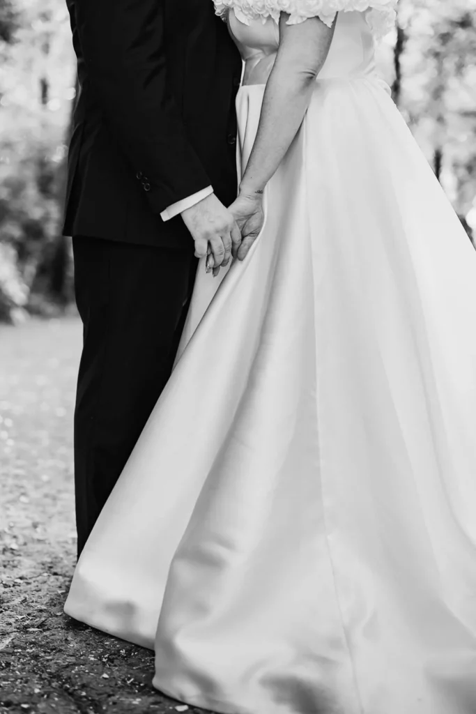 Close-up of bride’s gown as the couple prepares to exit the forest aisle