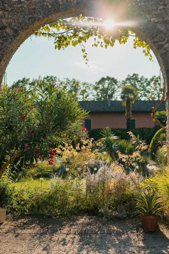 Garden pathway surrounded by wildflowers at Convento dell’Annunciata