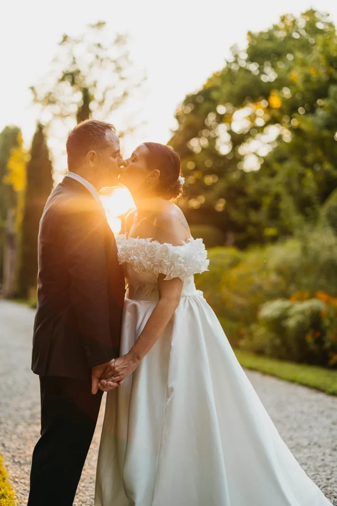 Romantic couple portrait with golden sunlight at the forest edge