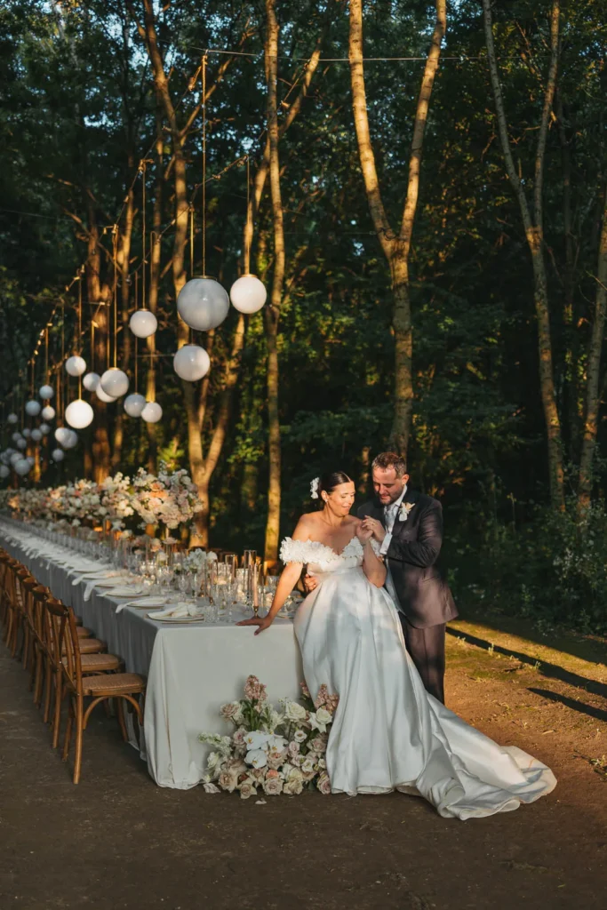 Bride and groom entering the reception dinner area decorated with lanterns