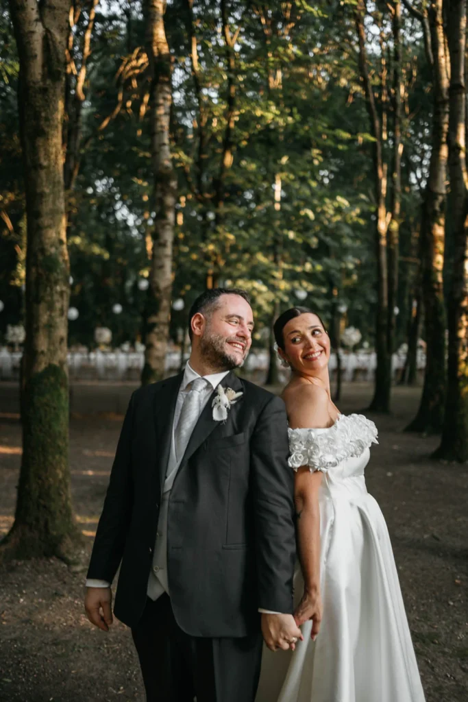 Joyful couple smiling after the cake cutting moment in the forest