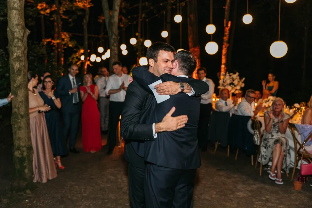 Emotional hug between guests during reception dinner