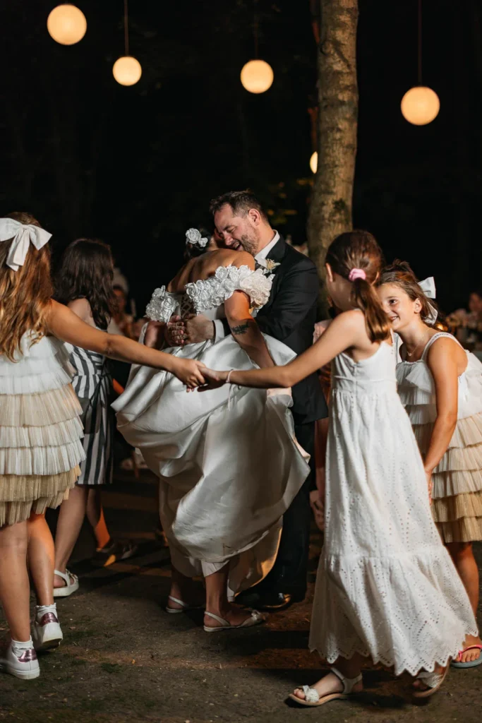 Bride dancing joyfully with friends and guests during the party