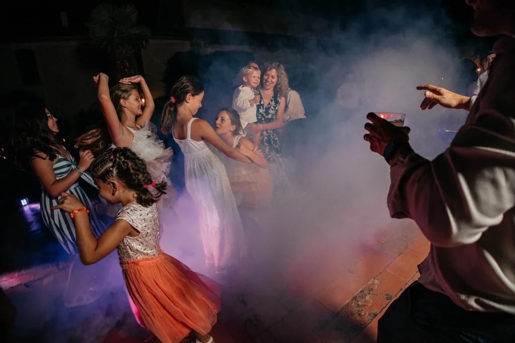 Guests dancing in smoke and colourful lights on the dance floor