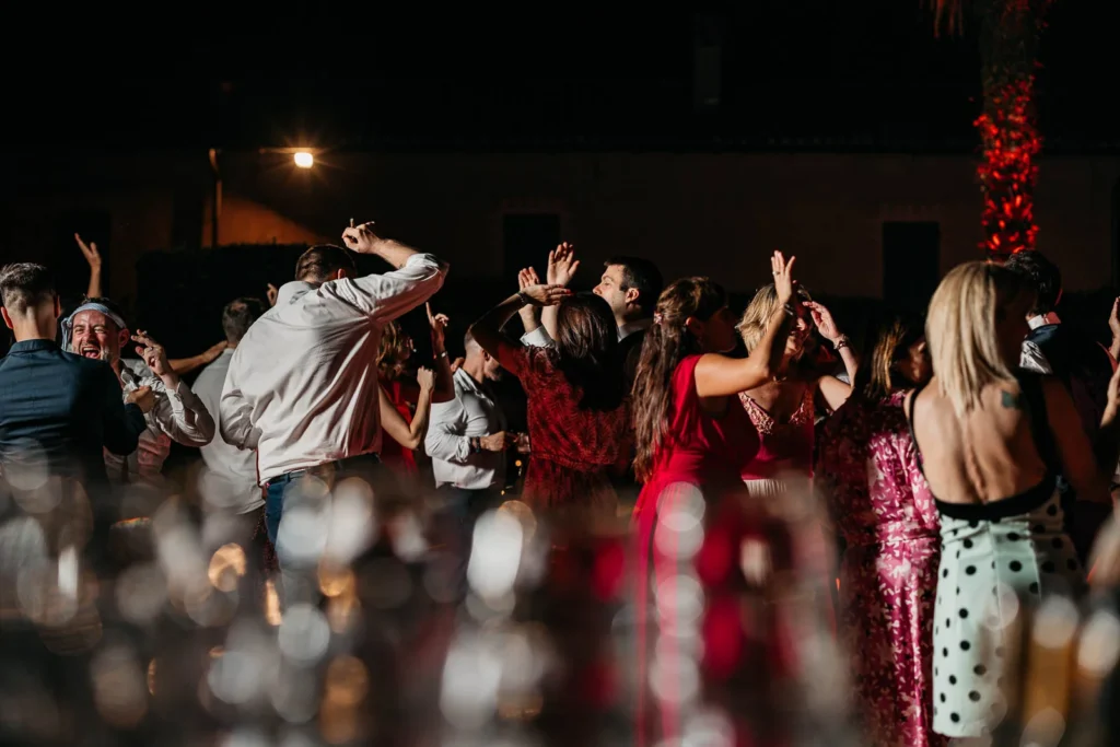 Guests dancing in motion blur and colourful lighting
